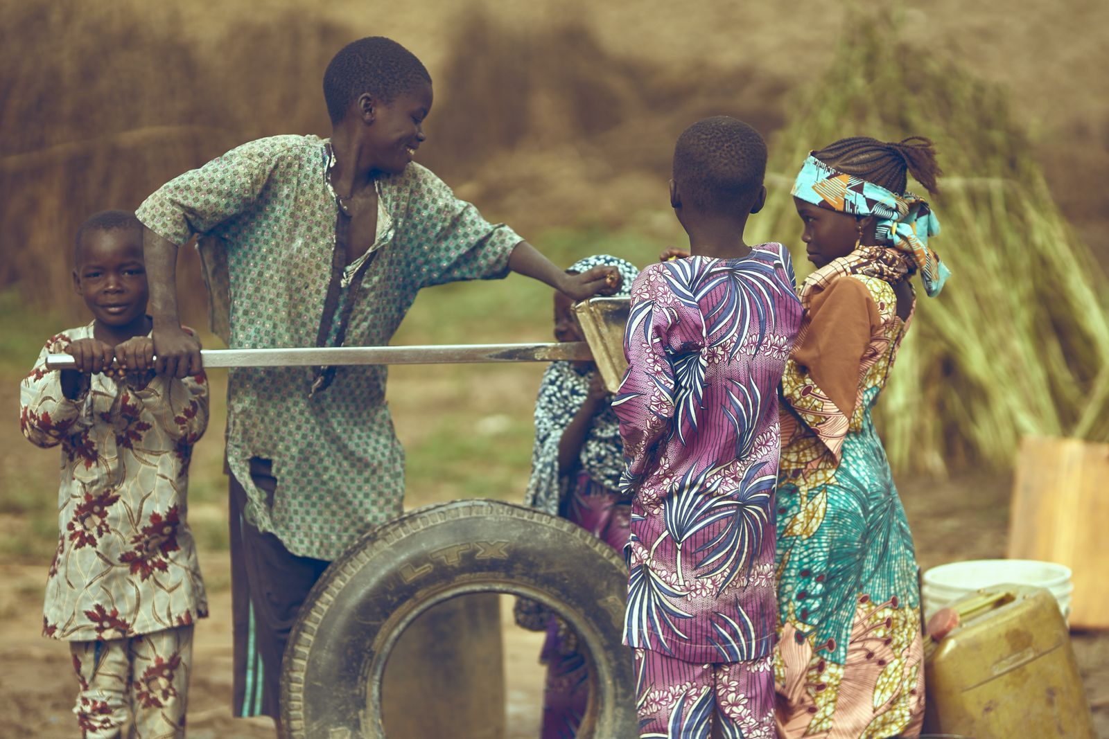 Amina with her children outside their home
